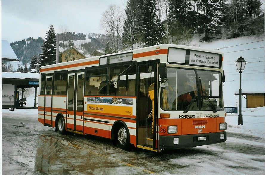 (083'133) - MOB Montreux - Nr. 26/BE 131'388 - MAN (ex BSF Hochdorf) am 19. Februar 2006 beim Bahnhof Gstaad